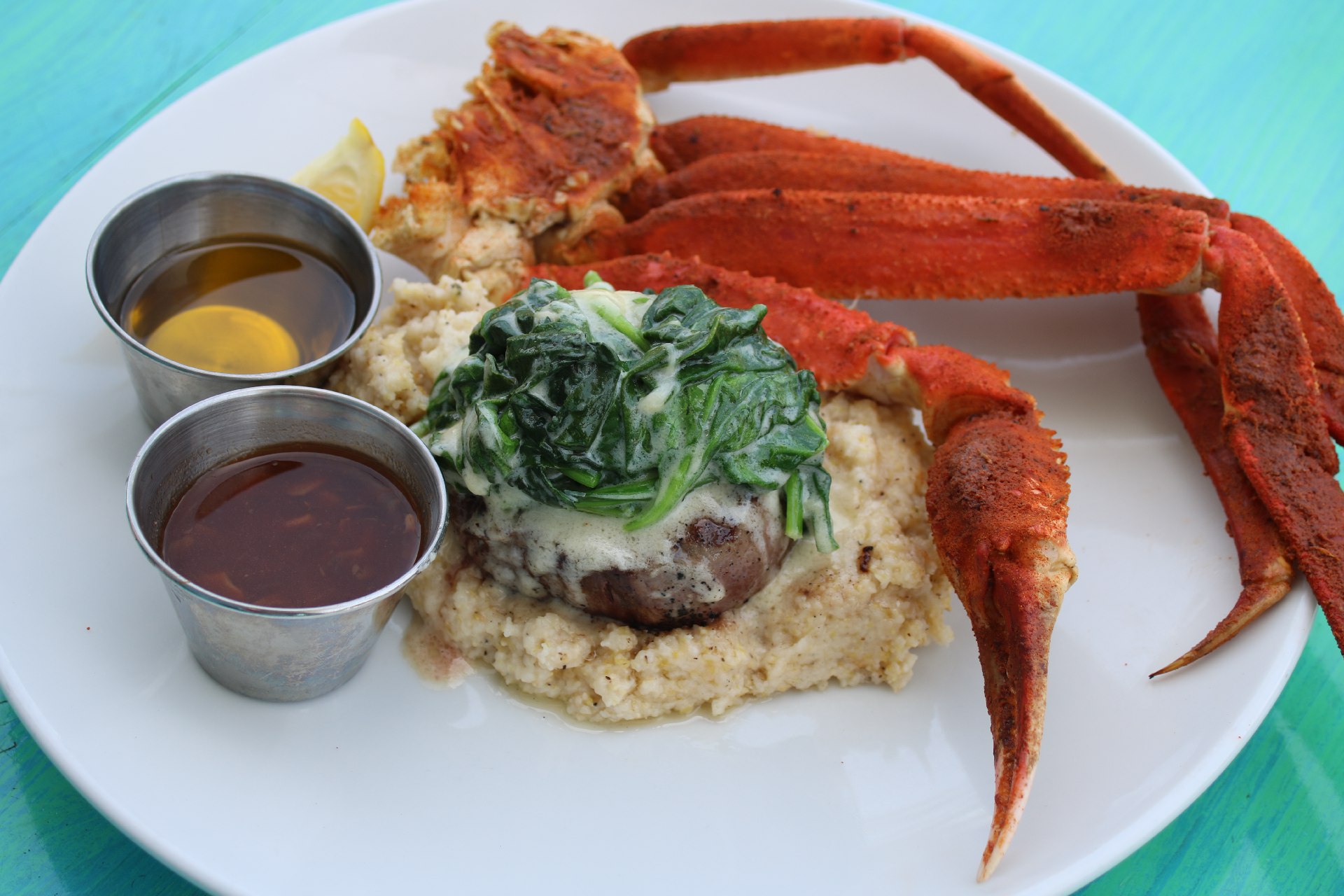beef medallion over Parmesan grits with snow crab legs